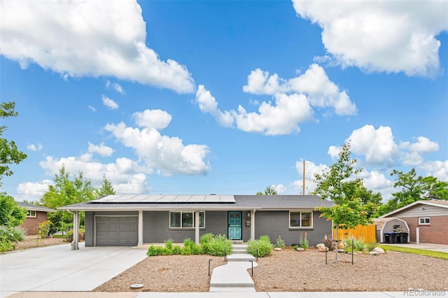 6066 Simms St, Arvada, CO 80004 - single story home featuring concrete driveway, roof mounted solar panels, a garage, and a porch