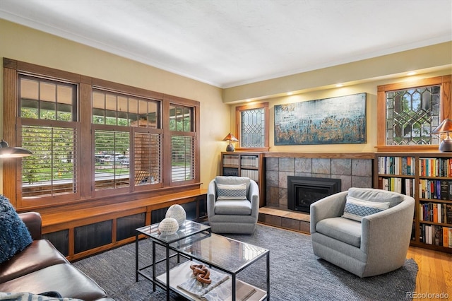 2201 Cherry St, Denver, CO 80207 - living area with a tile fireplace, crown molding, and wood finished floors