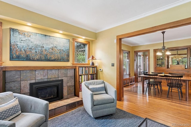 2201 Cherry St, Denver, CO 80207 - living area with crown molding, wood finished floors, and a fireplace