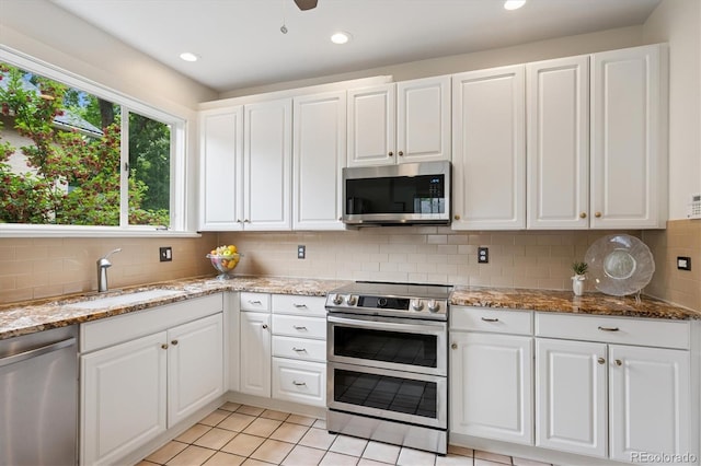 2201 Cherry St, Denver, CO 80207 - kitchen featuring appliances with stainless steel finishes, white cabinetry, and recessed lighting