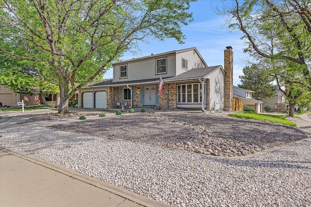 18263 E Mansfield Ave, Aurora, CO 80013 - traditional-style home with an attached garage, a chimney, driveway, and a porch