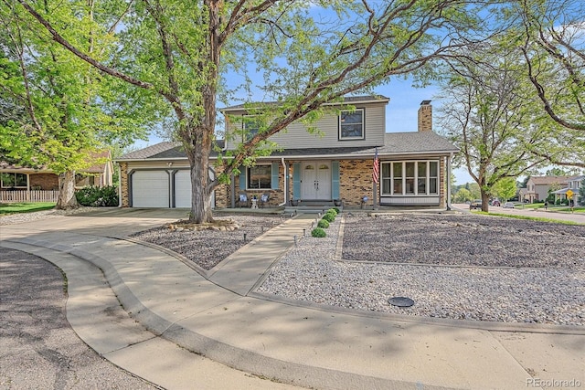 18263 E Mansfield Ave, Aurora, CO 80013 - traditional-style house with concrete driveway, an attached garage, covered porch, a chimney, and brick siding