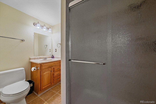 18263 E Mansfield Ave, Aurora, CO 80013 - bathroom featuring vanity, a stall shower, tile patterned floors, and toilet