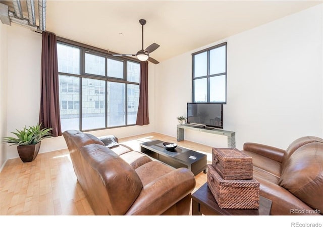3100 Huron St Unit 3P, Denver, CO 80202 - living area with plenty of natural light, wood finished floors, and a ceiling fan