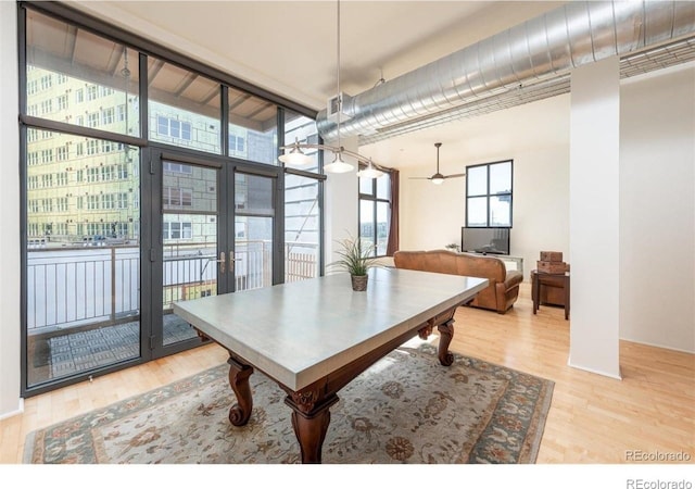 3100 Huron St Unit 3P, Denver, CO 80202 - dining space featuring wood finished floors, ceiling fan, and a high ceiling