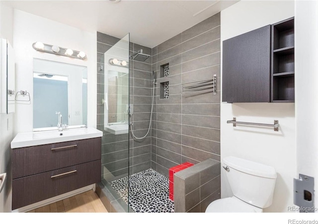 3100 Huron St Unit 3P, Denver, CO 80202 - bathroom with walk in shower, vanity, and wood finished floors