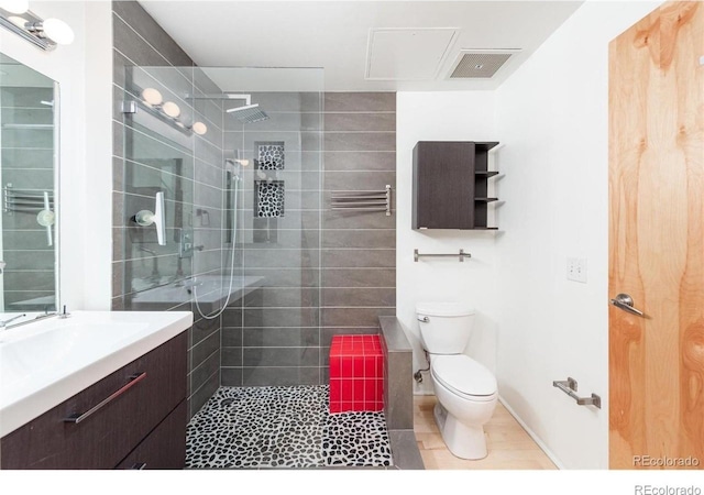 3100 Huron St Unit 3P, Denver, CO 80202 - full bathroom with a walk in shower, vanity, a towel warmer, and tile patterned floors