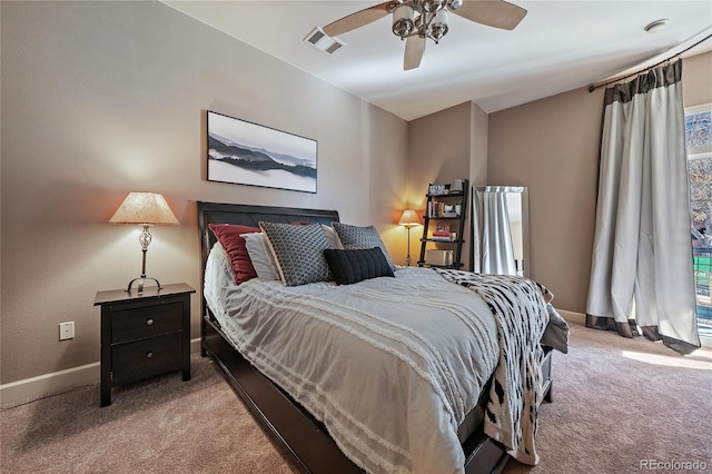 carpeted bedroom with a ceiling fan, visible vents, and baseboards