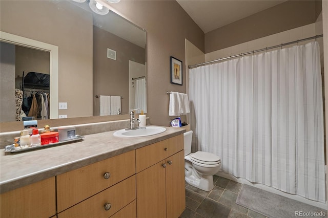 bathroom with visible vents, curtained shower, vanity, and toilet