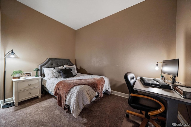 bedroom featuring vaulted ceiling, dark carpet, and baseboards