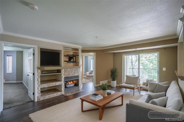 12208 W Dorado Pl Unit 207, Littleton, CO 80127 - living area with a textured ceiling, crown molding, a fireplace, and dark wood-type flooring