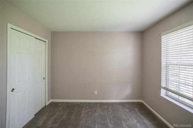 12208 W Dorado Pl Unit 207, Littleton, CO 80127 - unfurnished bedroom featuring dark colored carpet and a closet