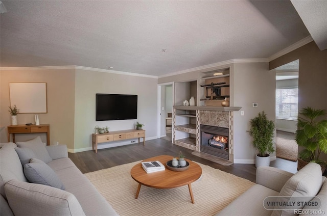 12208 W Dorado Pl Unit 207, Littleton, CO 80127 - living room with dark wood-style floors, a textured ceiling, a fireplace, ornamental molding, and built in features
