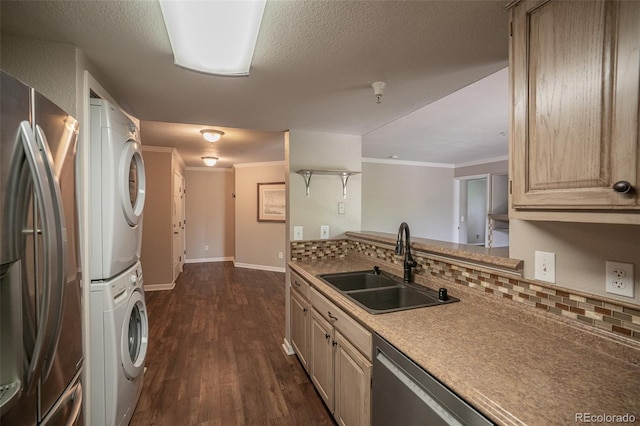 12208 W Dorado Pl Unit 207, Littleton, CO 80127 - kitchen featuring appliances with stainless steel finishes, stacked washer / dryer, backsplash, dark wood finished floors, and ornamental molding