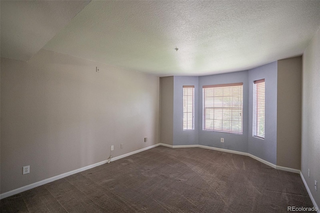 12208 W Dorado Pl Unit 207, Littleton, CO 80127 - spare room with dark carpet and a textured ceiling