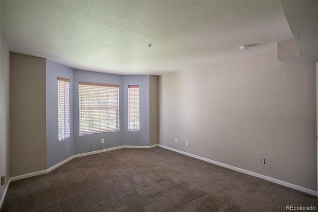 12208 W Dorado Pl Unit 207, Littleton, CO 80127 - spare room with dark colored carpet, a smoke detector, and a textured ceiling