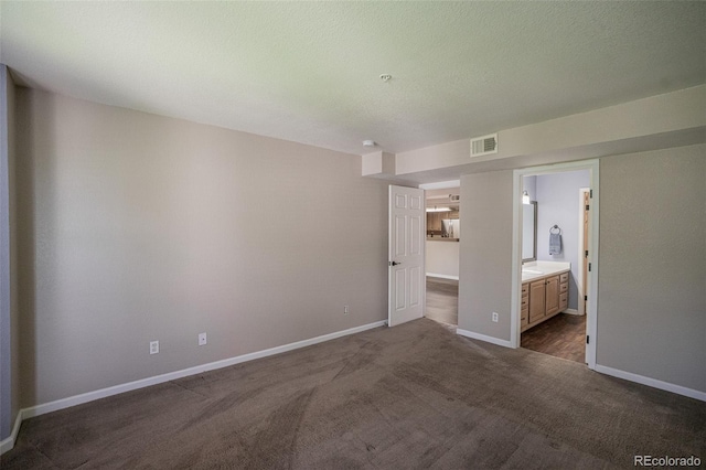 12208 W Dorado Pl Unit 207, Littleton, CO 80127 - unfurnished bedroom featuring dark colored carpet and ensuite bathroom