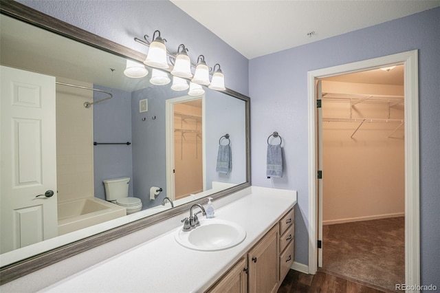 12208 W Dorado Pl Unit 207, Littleton, CO 80127 - bathroom with vanity, wood finished floors, shower / tub combination, and a spacious closet