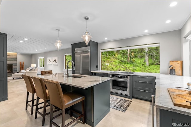 592 Brook Dr, Idaho Springs, CO 80452 - kitchen featuring appliances with stainless steel finishes, light stone counters, recessed lighting, a breakfast bar, and gray cabinetry