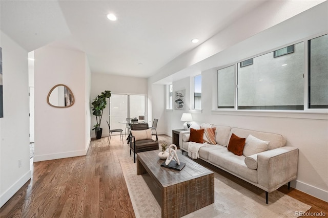 living room featuring recessed lighting, wood finished floors, and baseboards