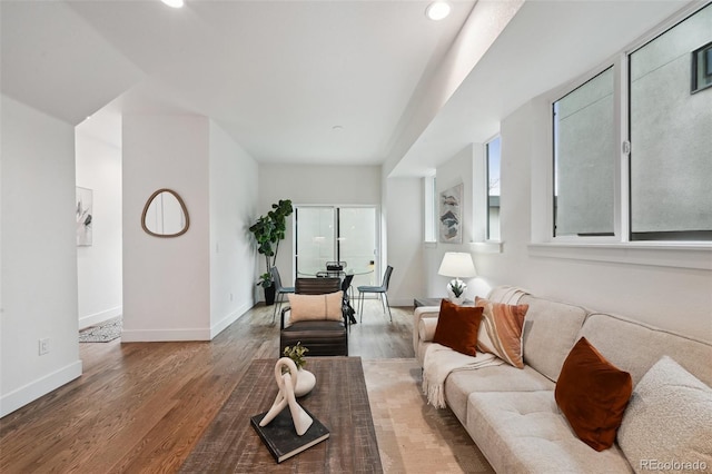 living area featuring baseboards, wood finished floors, and recessed lighting