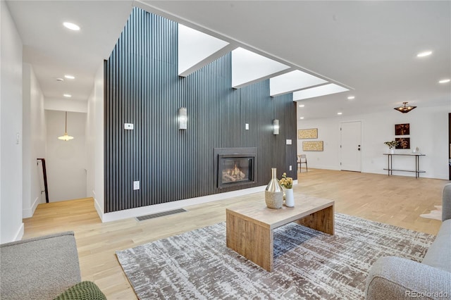 456 Cherry St, Denver, CO 80220 - living area featuring light wood-type flooring, a glass covered fireplace, baseboards, and recessed lighting