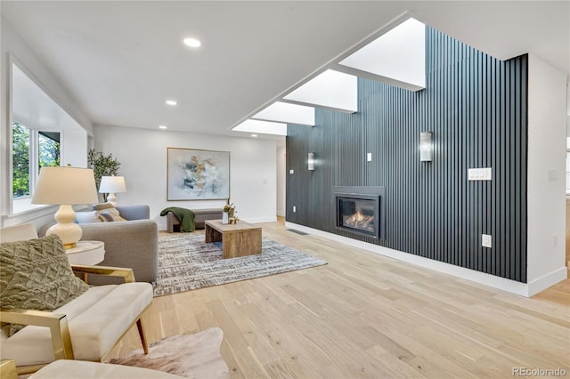 456 Cherry St, Denver, CO 80220 - living room featuring baseboards, wood finished floors, an accent wall, and recessed lighting