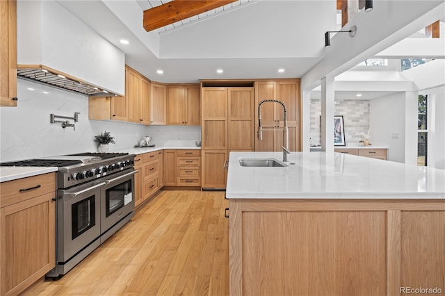 456 Cherry St, Denver, CO 80220 - kitchen featuring range with two ovens, a sink, light wood finished floors, backsplash, and light countertops