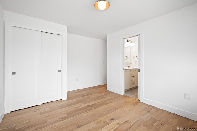 456 Cherry St, Denver, CO 80220 - unfurnished bedroom featuring light wood finished floors, baseboards, a closet, connected bathroom, and a sink