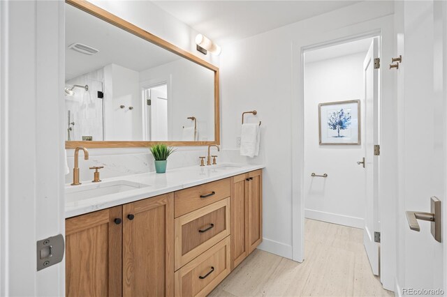 456 Cherry St, Denver, CO 80220 - full bathroom featuring double vanity, a stall shower, wood finished floors, and baseboards