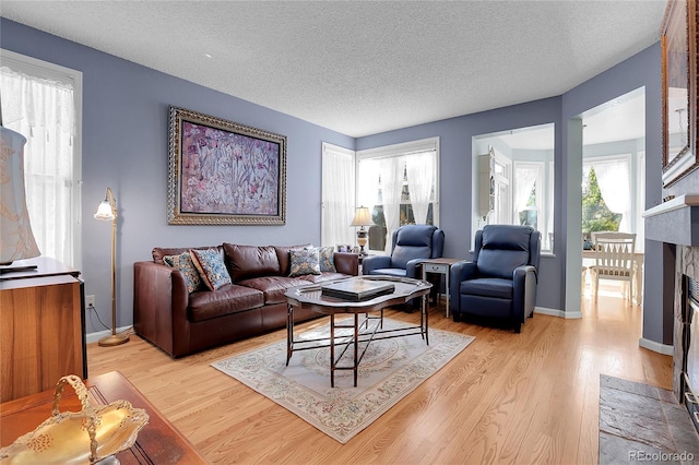 living room featuring a textured ceiling and light hardwood / wood-style flooring