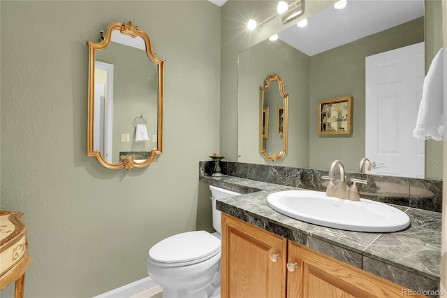 bathroom featuring vanity and toilet