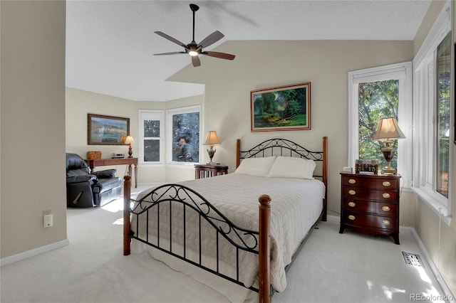 carpeted bedroom with lofted ceiling, ceiling fan, and a textured ceiling