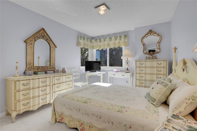 bedroom featuring carpet floors and a textured ceiling