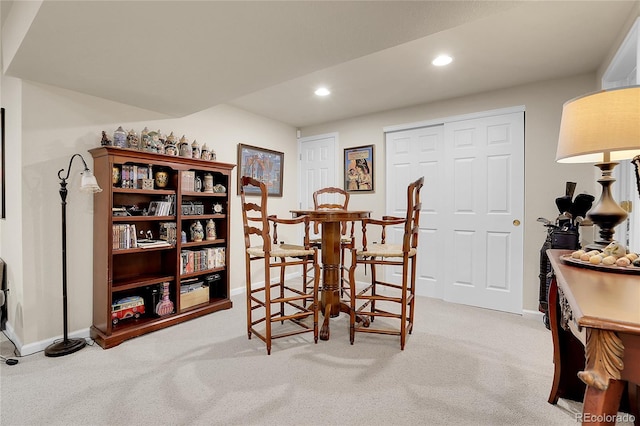 dining room featuring light carpet