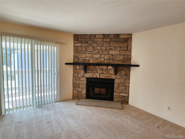 unfurnished living room with a fireplace and carpet flooring