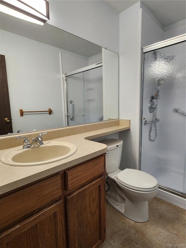 full bathroom with toilet, a stall shower, and vanity