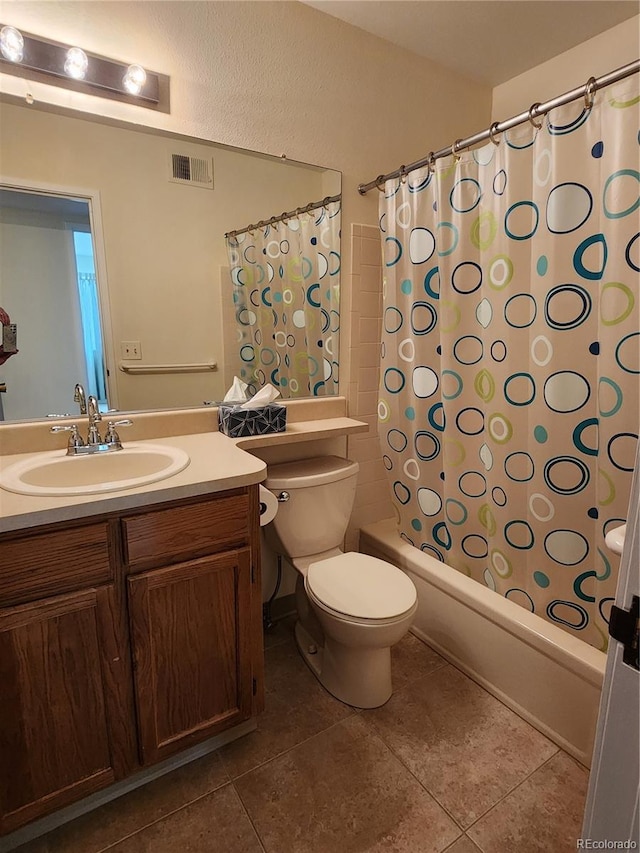 full bathroom featuring toilet, vanity, visible vents, tile patterned floors, and shower / tub combo with curtain