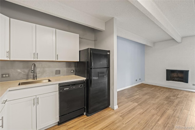 555 E 10th Ave Unit 111, Denver, CO 80203 - kitchen featuring black appliances, a sink, light countertops, white cabinets, and beam ceiling