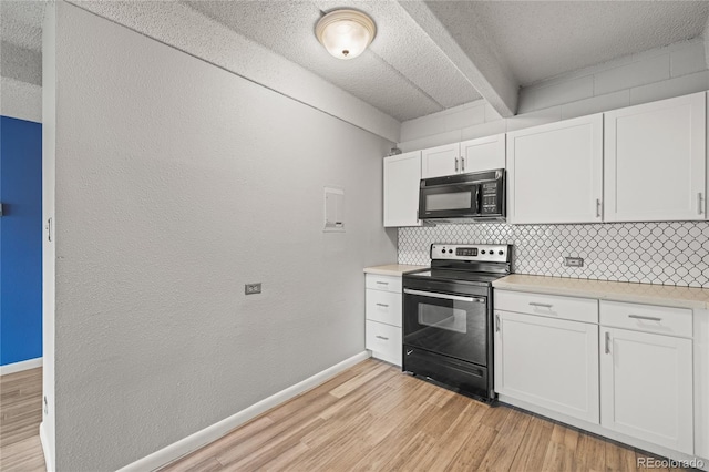 555 E 10th Ave Unit 111, Denver, CO 80203 - kitchen featuring black appliances, decorative backsplash, light wood-type flooring, light countertops, and a textured ceiling