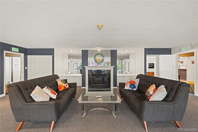 555 E 10th Ave Unit 111, Denver, CO 80203 - carpeted living room with a premium fireplace and a textured ceiling