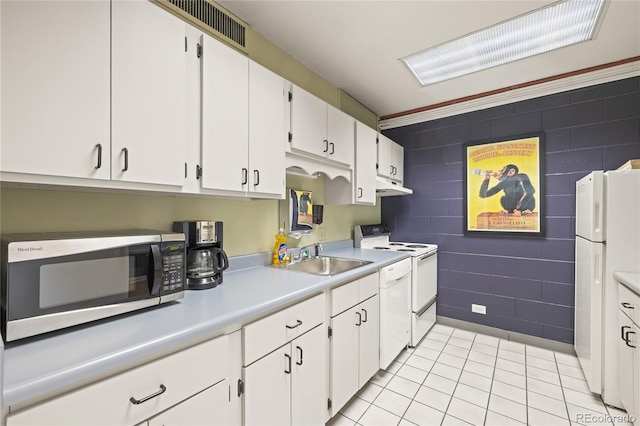 555 E 10th Ave Unit 111, Denver, CO 80203 - kitchen with white appliances, a sink, tile walls, under cabinet range hood, and light countertops