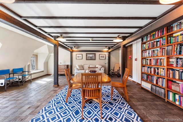 555 E 10th Ave Unit 111, Denver, CO 80203 - dining area featuring beam ceiling, baseboards, and built in shelves