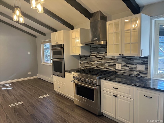 kitchen featuring white cabinets, decorative backsplash, wall chimney range hood, and appliances with stainless steel finishes