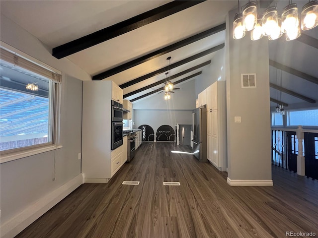 unfurnished living room with vaulted ceiling with beams, ceiling fan, dark hardwood / wood-style floors, and plenty of natural light