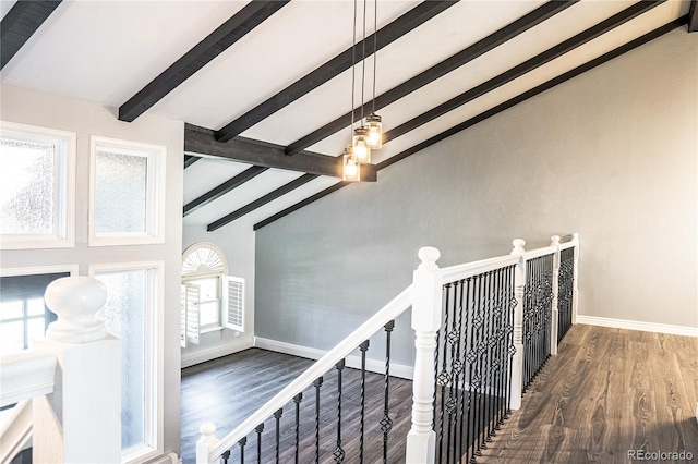 staircase with lofted ceiling with beams and hardwood / wood-style flooring