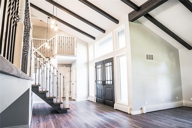 foyer with beam ceiling, dark hardwood / wood-style floors, high vaulted ceiling, and french doors