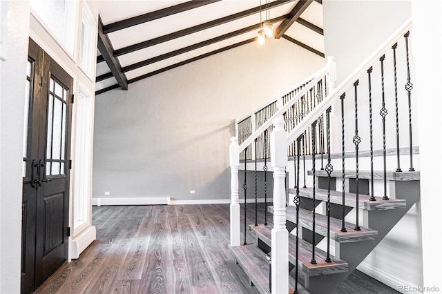 foyer with beam ceiling, high vaulted ceiling, dark wood-type flooring, and a baseboard heating unit