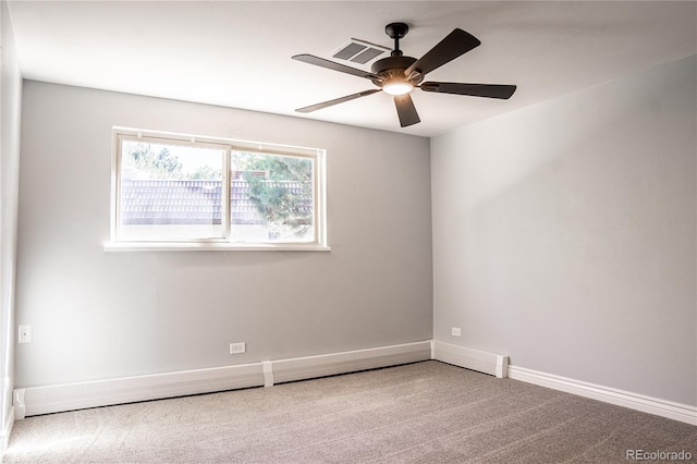 carpeted spare room featuring ceiling fan