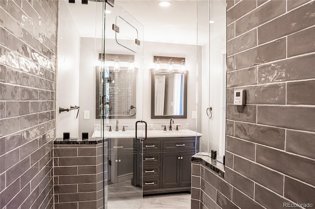 bathroom featuring vanity and an enclosed shower